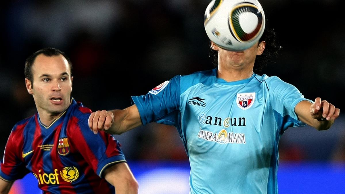 Barcelona's Andres Iniesta (L) approaches Daniel Arreola of Mexico's Atlante as he controls the ball during their 2009 FIFA Club World Cup semi-final football match in Abu Dhabi on December 16, 2009. European champions Barcelona produced a masterclass to beat Mexican side Atlante 3-1 and book their place in the World Club Cup final. AFP PHOTO/MARWAN NAAMANI (Photo credit should read MARWAN NAAMANI/AFP/Getty Images)